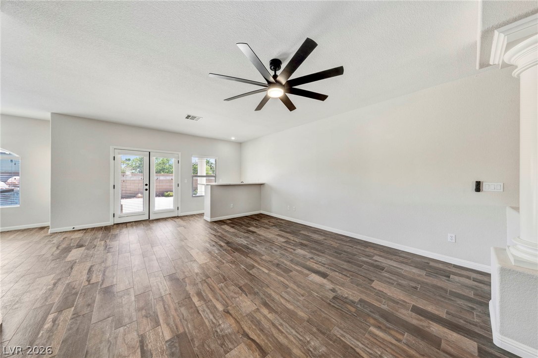 740 Aldo Rae Court, Unit NONE Henderson, NV 89052 - Photo 8 of 35 A spacious living area features ceramic tile flooring and abundant natural light from the patio doors.
