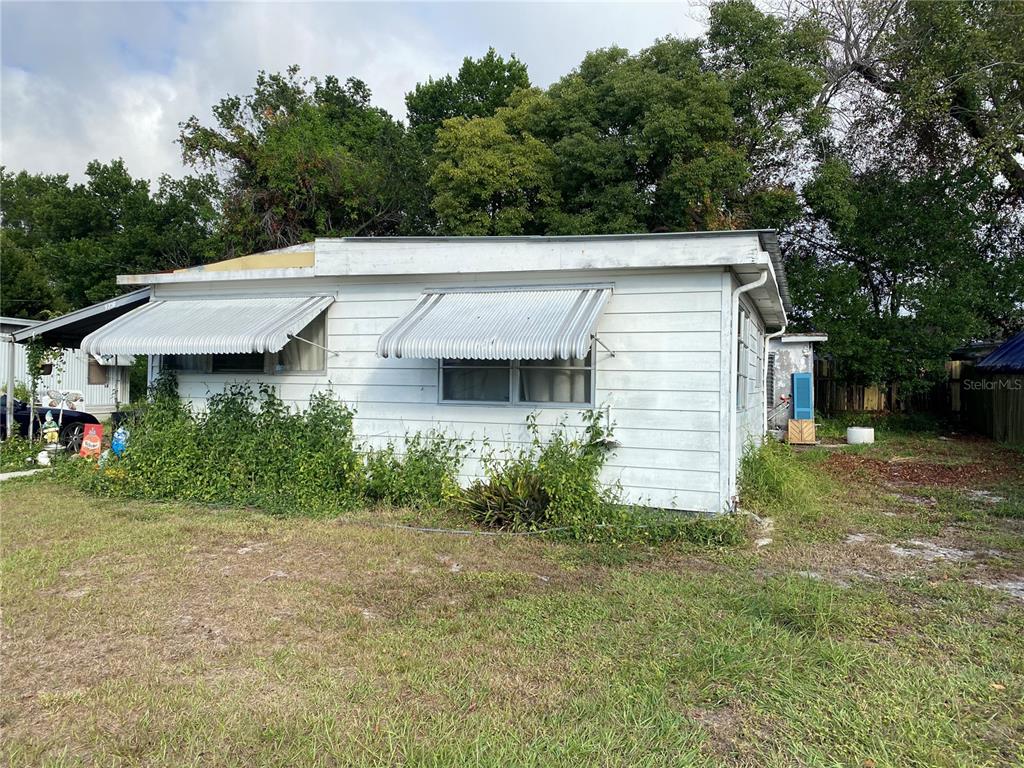 9736 Warrick Street Port Richey, FL 34668 - Photo 1 of 1 a view of a white house next to a yard and a large tree