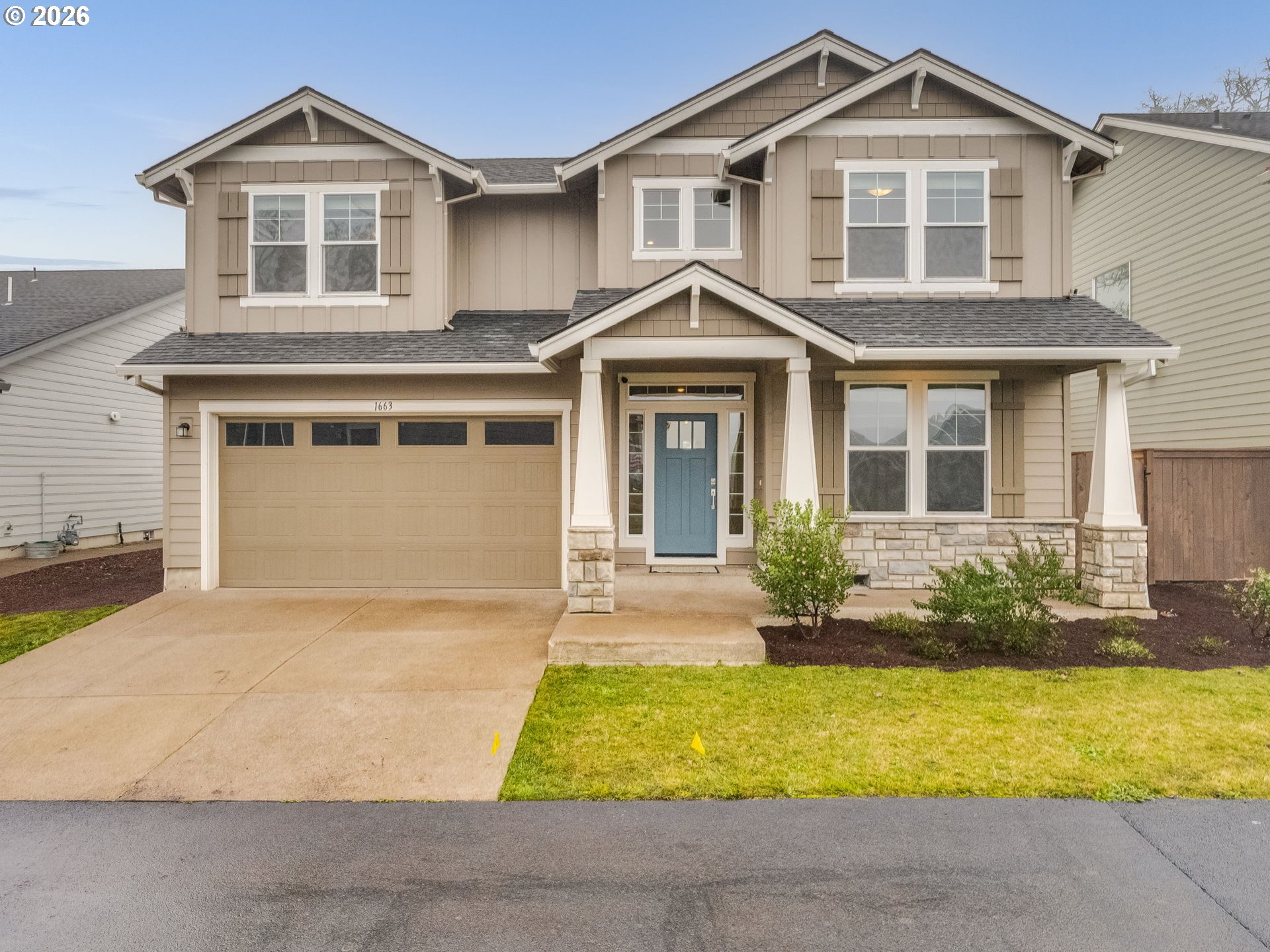 a front view of a house with yard and garage