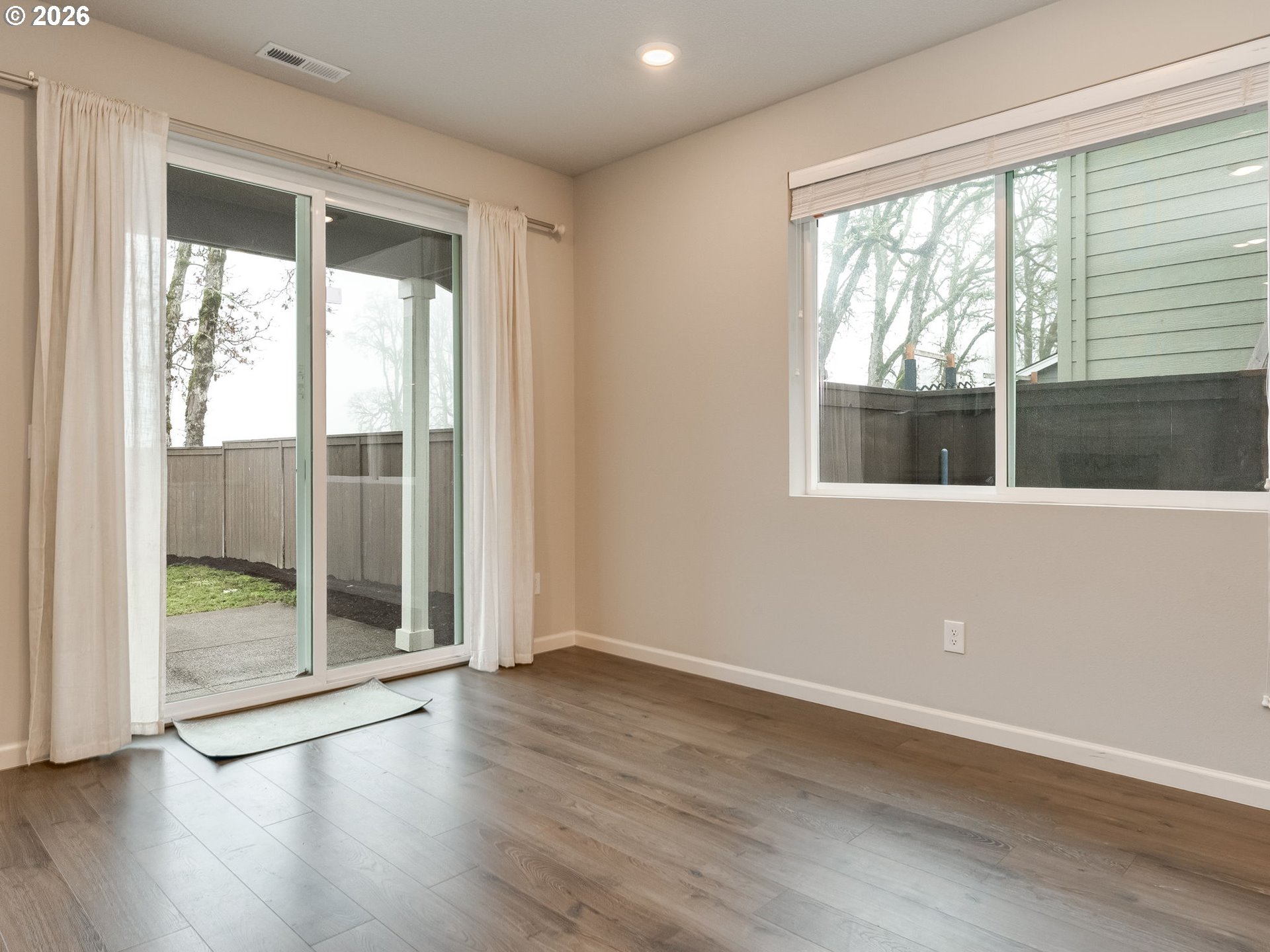 1663 Northwest Edgar Street McMinnville, OR 97128 - Photo 12 of 44 an empty room with wooden floor and windows
