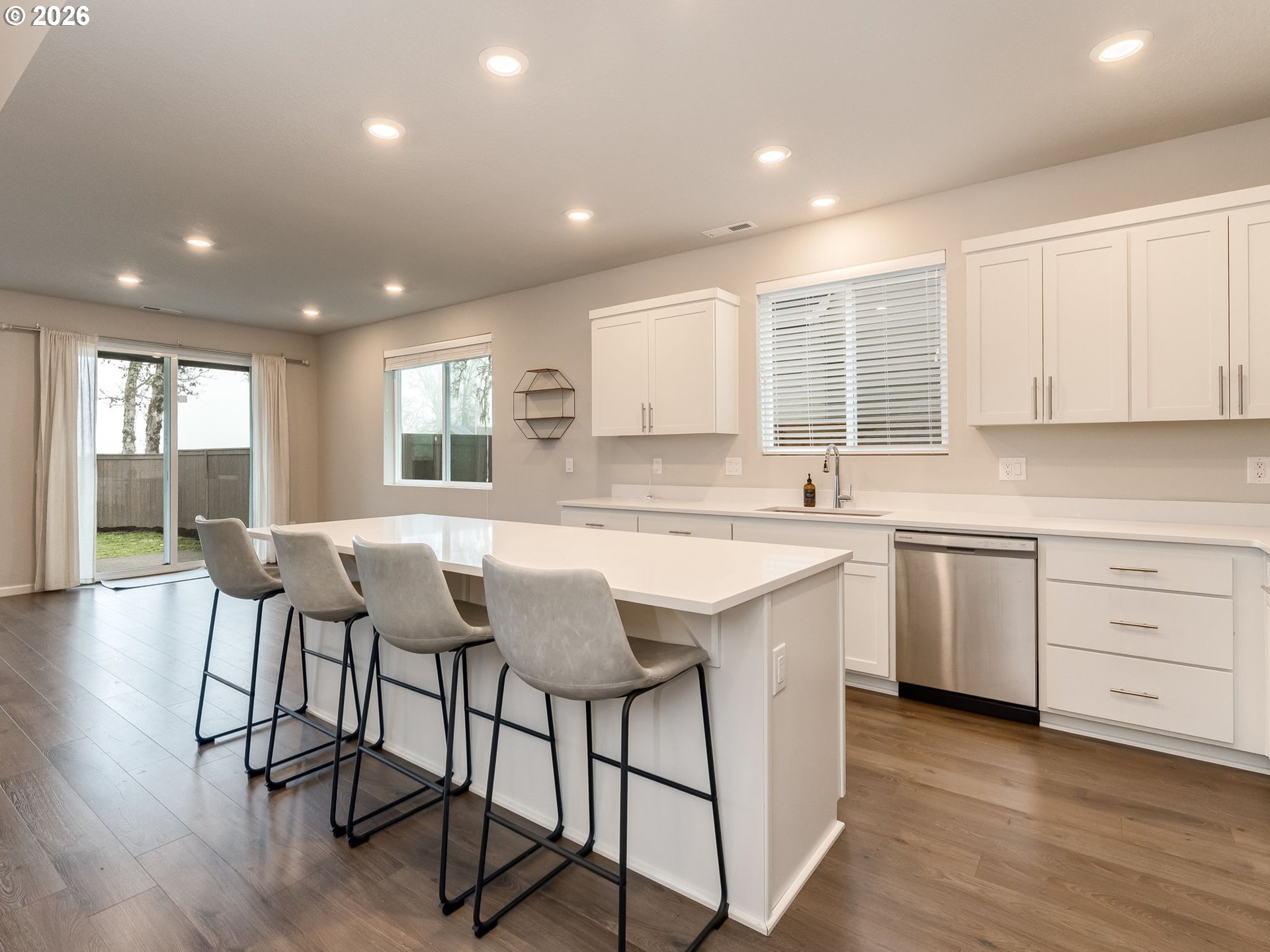 1663 Northwest Edgar Street McMinnville, OR 97128 - Photo 19 of 44 a kitchen with granite countertop white cabinets and chairs