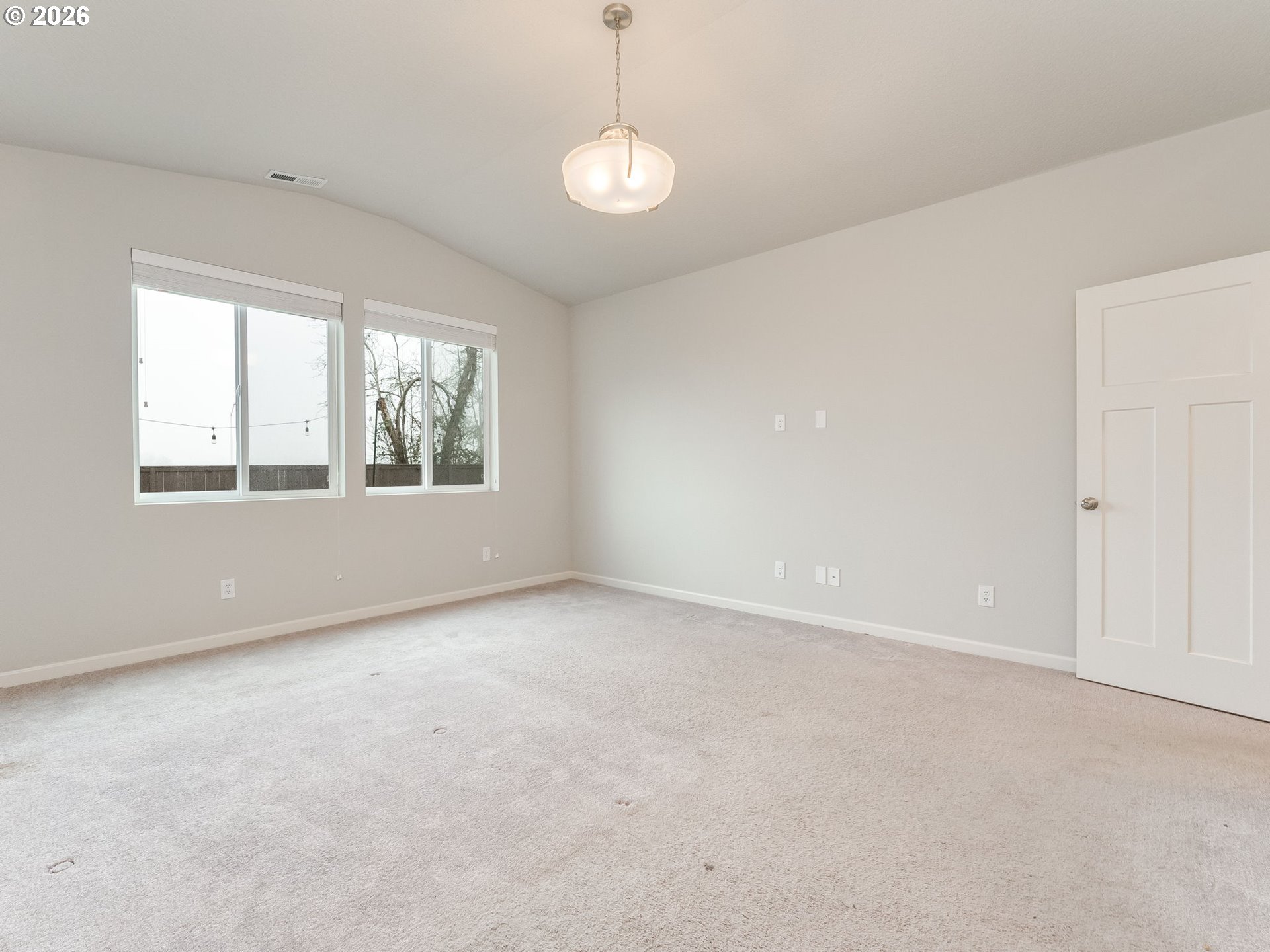 1663 Northwest Edgar Street McMinnville, OR 97128 - Photo 24 of 44 an empty room with windows and chandelier fan