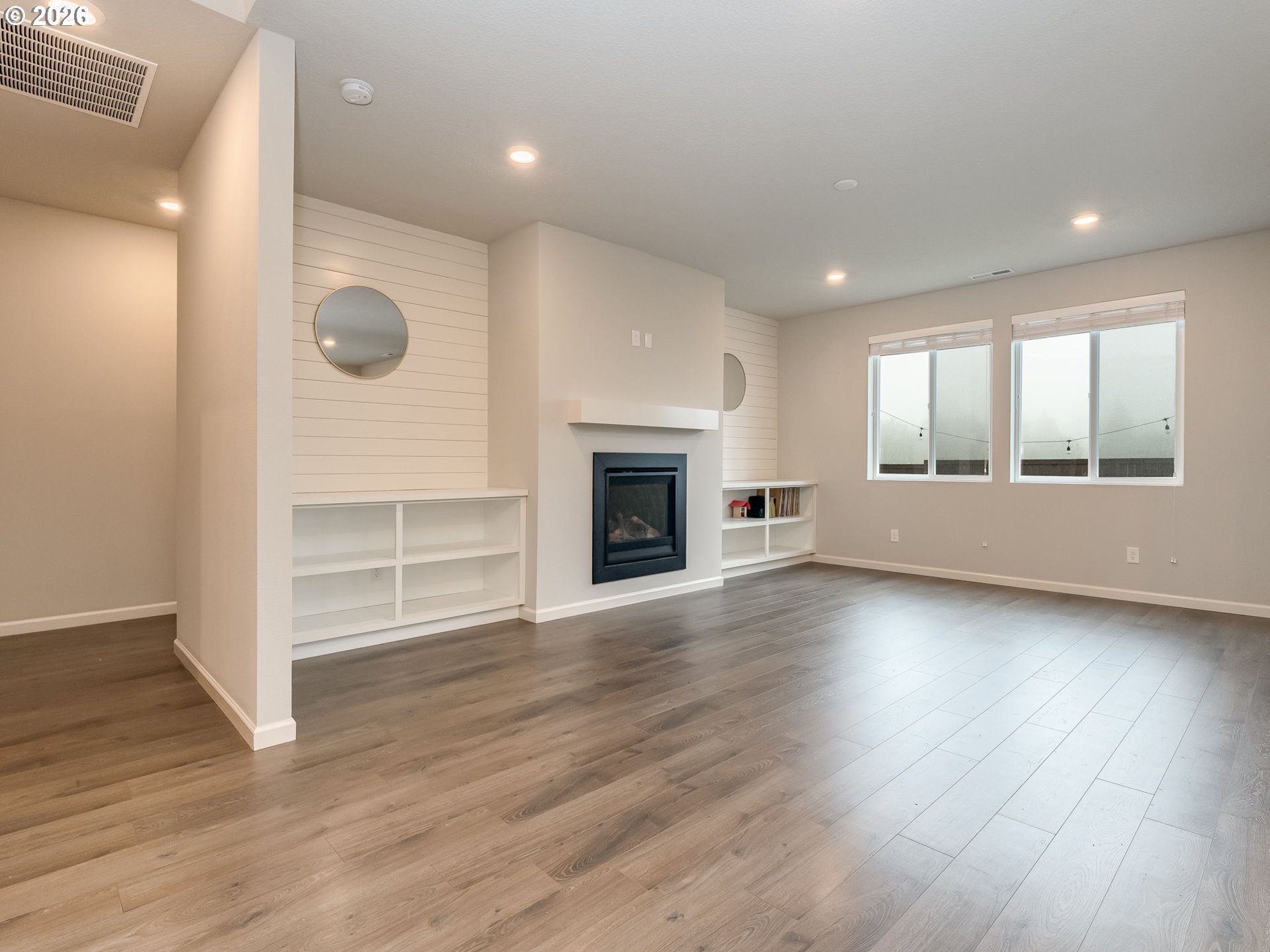 1663 Northwest Edgar Street McMinnville, OR 97128 - Photo 8 of 44 an empty room with wooden floor and fireplace