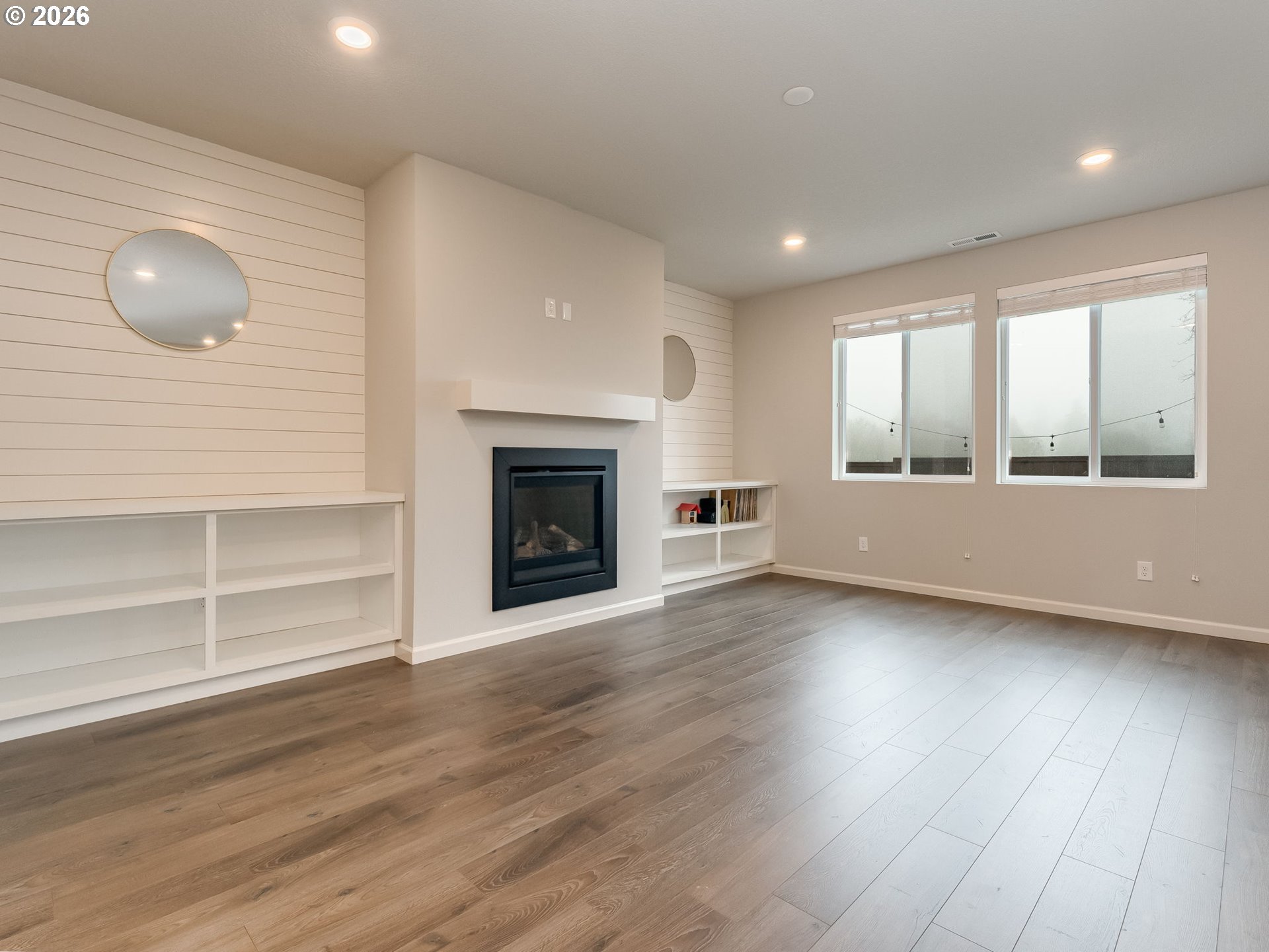 1663 Northwest Edgar Street McMinnville, OR 97128 - Photo 9 of 44 a view of a livingroom with wooden floor and a fireplace