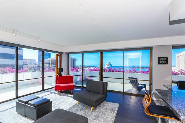 a living room with furniture and floor to ceiling window