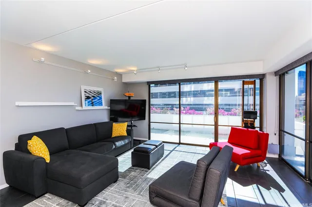 a living room with furniture and large windows