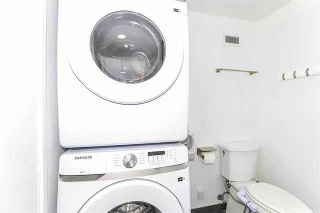 a utility room with dryer and cars