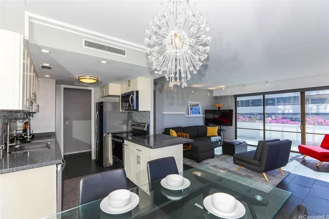 a view of a dining room with furniture a chandelier and large window