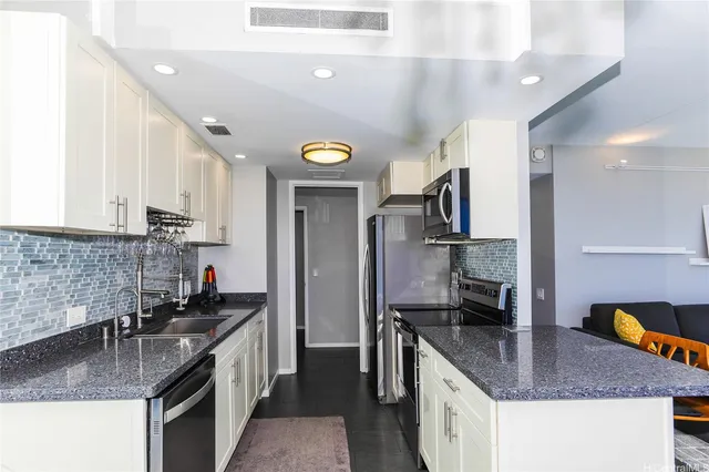 a kitchen with stainless steel appliances granite countertop a sink stove and refrigerator