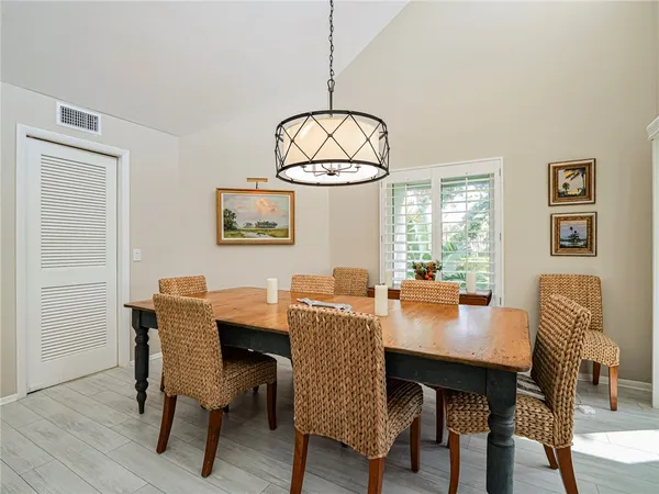 a dining room with furniture a window and wooden floor