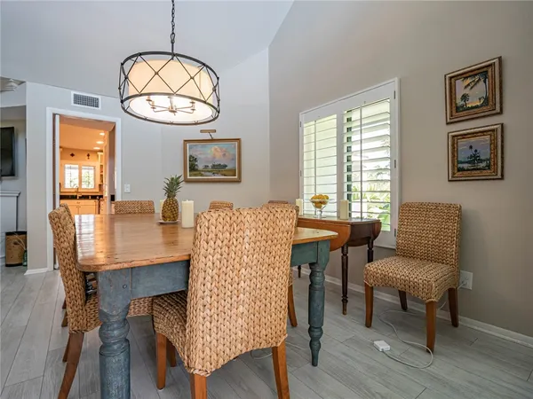 a living room with furniture a table and a large window