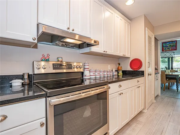 a kitchen with stainless steel appliances granite countertop a stove and a sink
