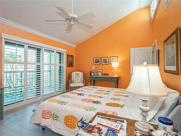 a bedroom with a bed and a large window