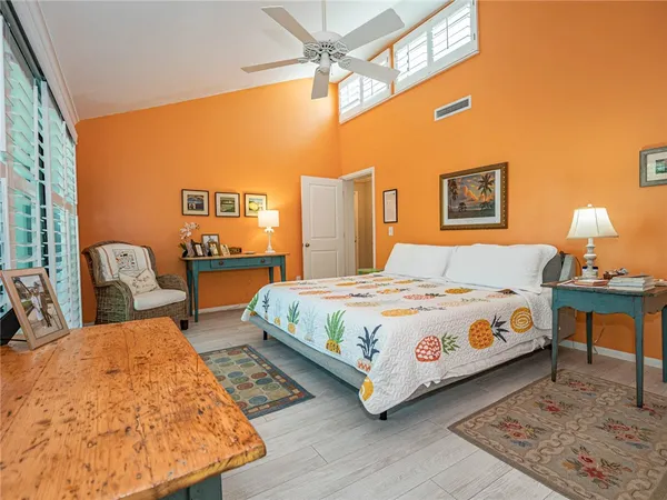 a bedroom with a bed a lamp and a table