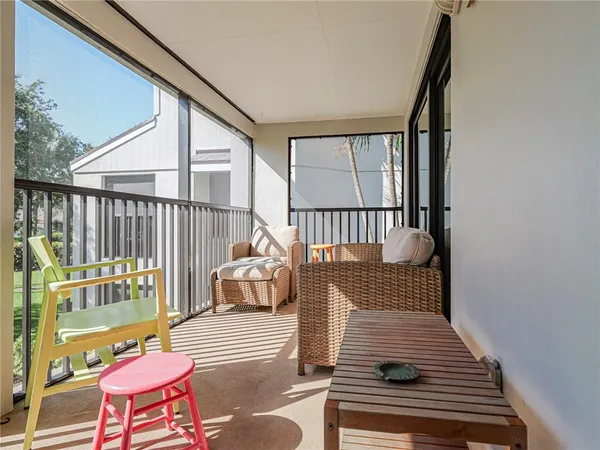 a view of a balcony with wooden floor