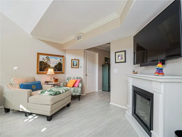 a living room with furniture a flat screen tv and a fireplace