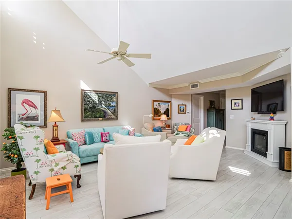 a living room with fireplace furniture and a flat screen tv