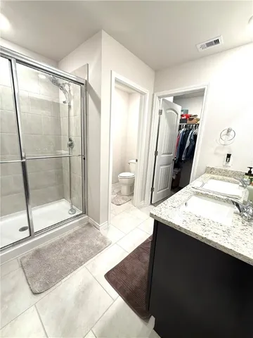a en suite bathroom with a granite countertop sink