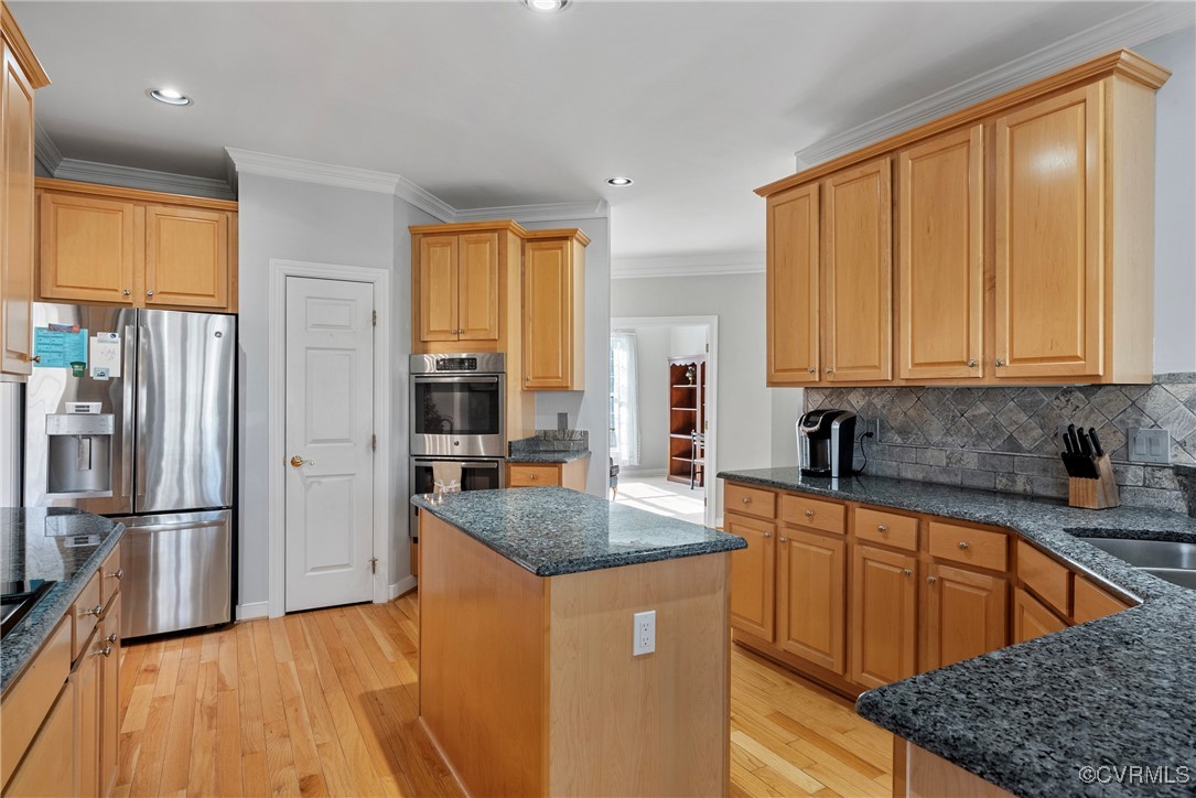 9134 Stephens Manor Drive Mechanicsville, VA 23116 - Photo 13 of 44 Kitchen featuring crown molding, backsplash, stain
