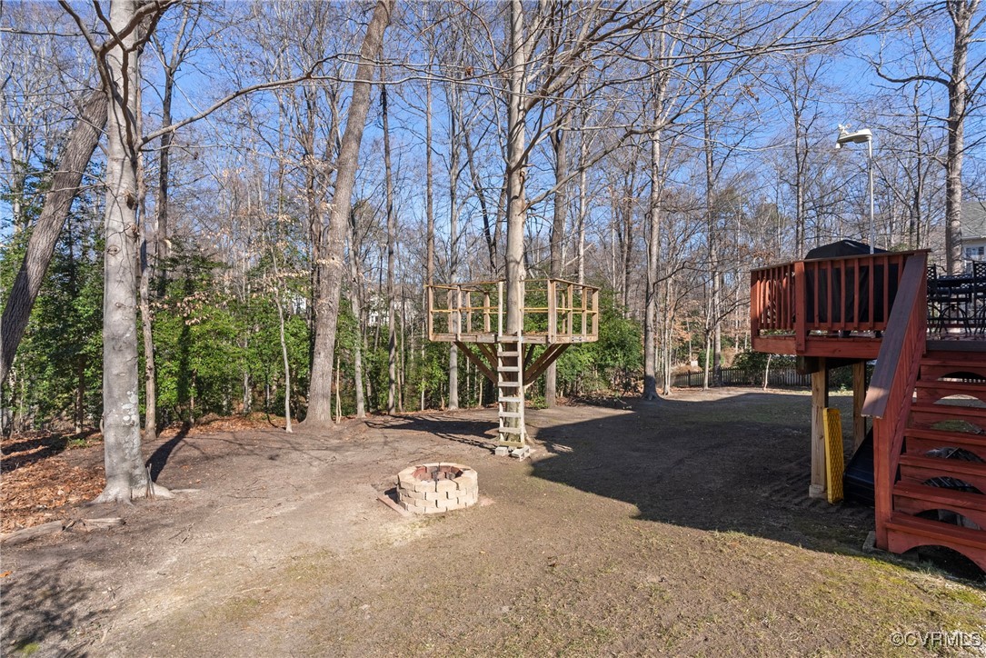 9134 Stephens Manor Drive Mechanicsville, VA 23116 - Photo 38 of 44 View of yard with a wooden deck and an outdoor fir