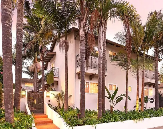 a backyard of a residential building with multiple trees