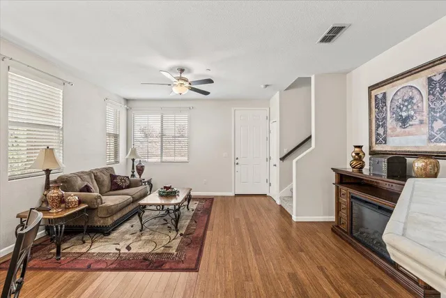 a living room with furniture and a wooden floor