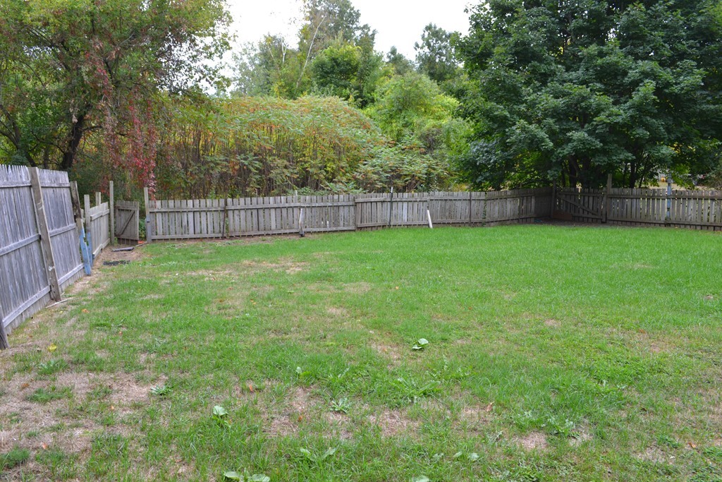 77 North Street Three Rivers, MA 01080 - Photo 19 of 20 a view of a yard with a fence and trees