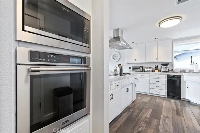 a view of a balcony with two chairs and a potted plant
