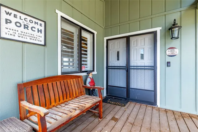 a living room with furniture a fireplace a flat screen tv and a large window