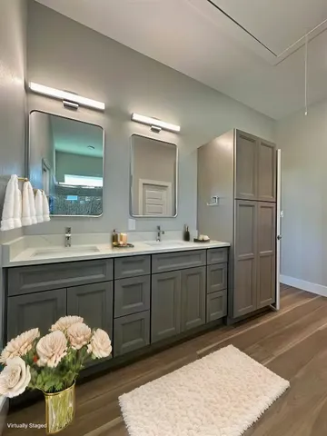 a spacious bathroom with a sink a vanity and a mirror