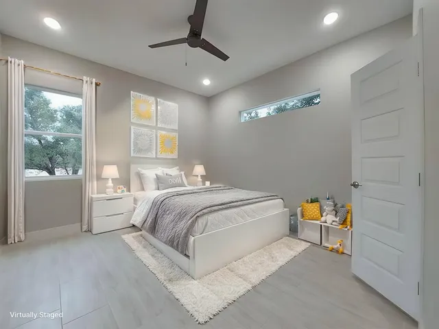 a spacious bedroom with a large bed and a chandelier