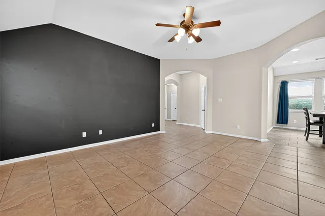 an empty room with closet and a chandelier fan
