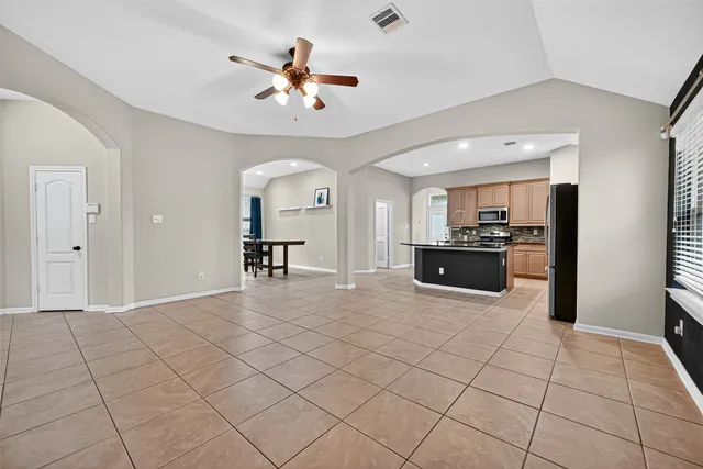a view of a livingroom with furniture and a kitchen view