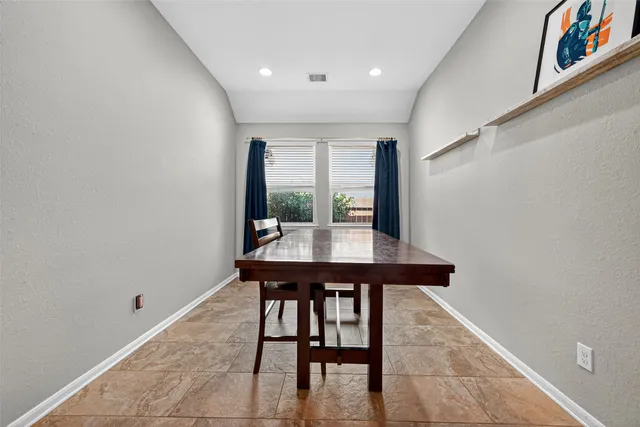 a view of a room with a table and chairs