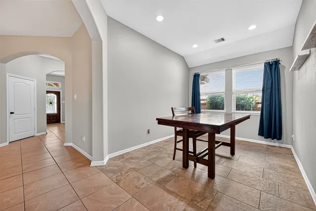 a dining room with furniture and window