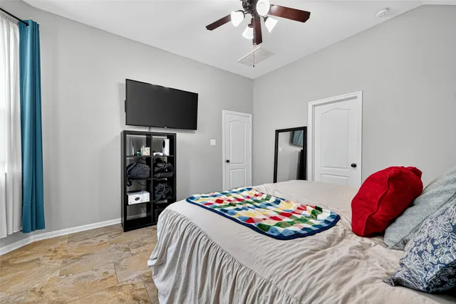 a bedroom with a bed and a flat screen tv