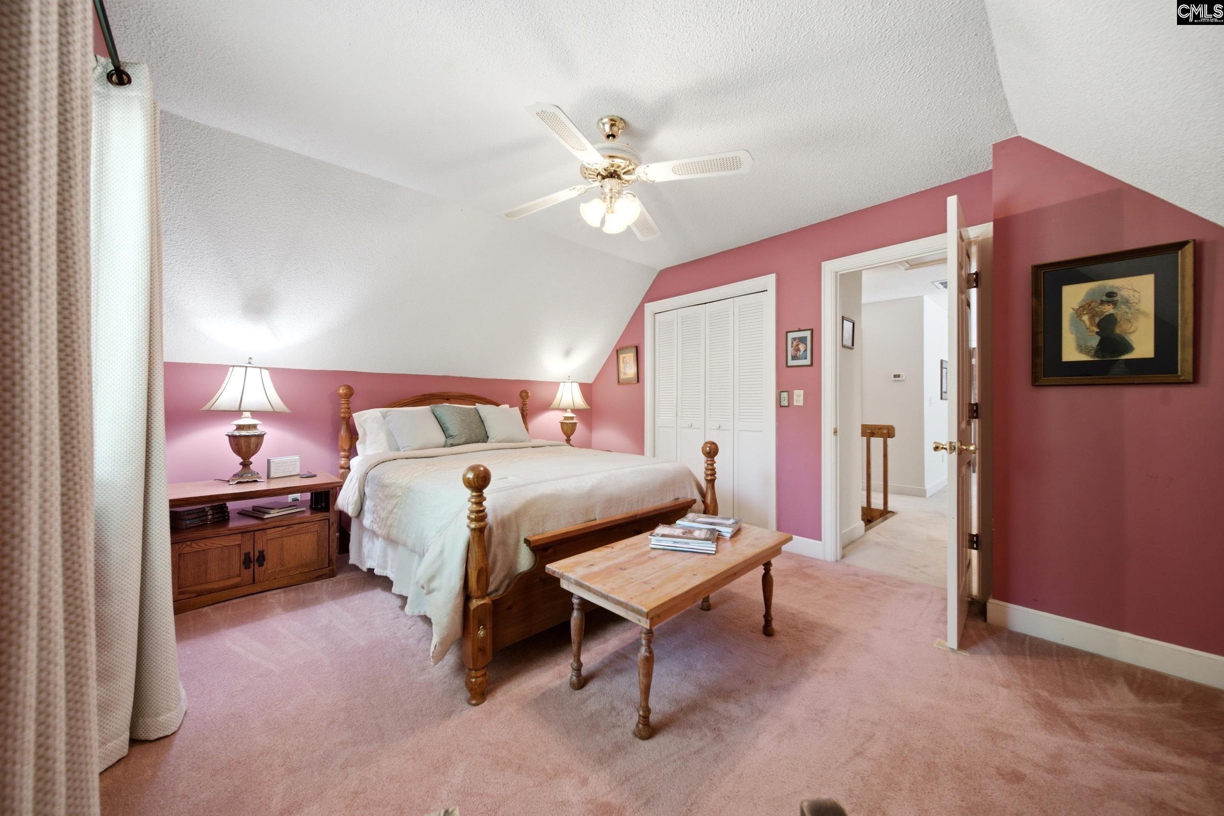 4324 Syrup Mill Road Ridgeway, SC 29130 - Photo 35 of 61 a bedroom with a bed and a chandelier