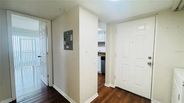 a view of a hallway with wooden floor