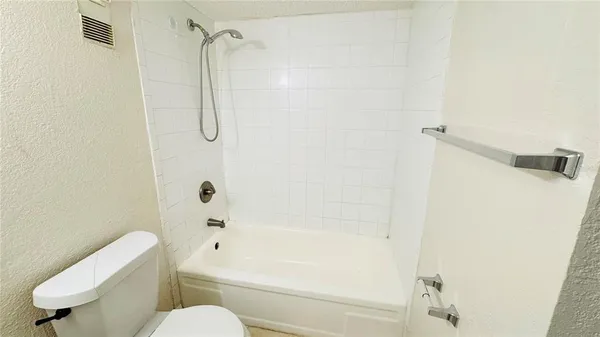 a bathroom with a shower a toilet and a sink