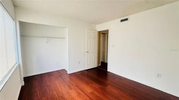 an empty room with wooden floor