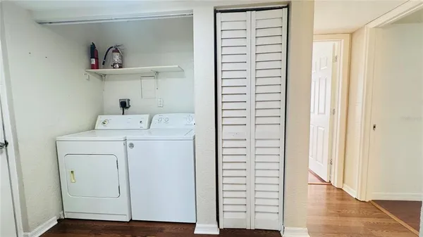 a utility room with cabinets washer and dryer