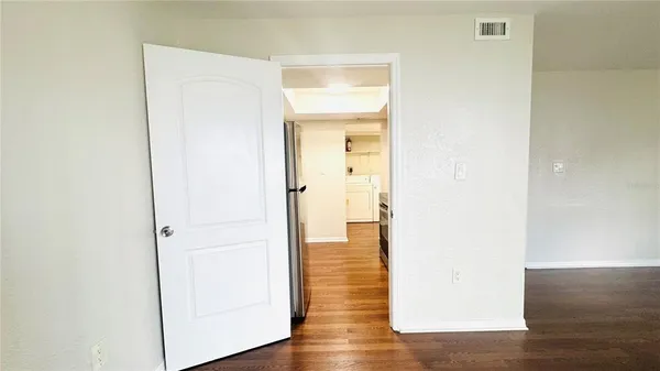 a view of a hallway with wooden floor