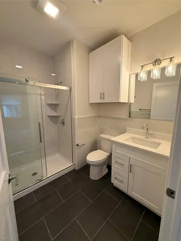 a bathroom with a toilet sink and shower