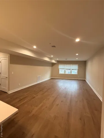a view of room and hall with wooden floor
