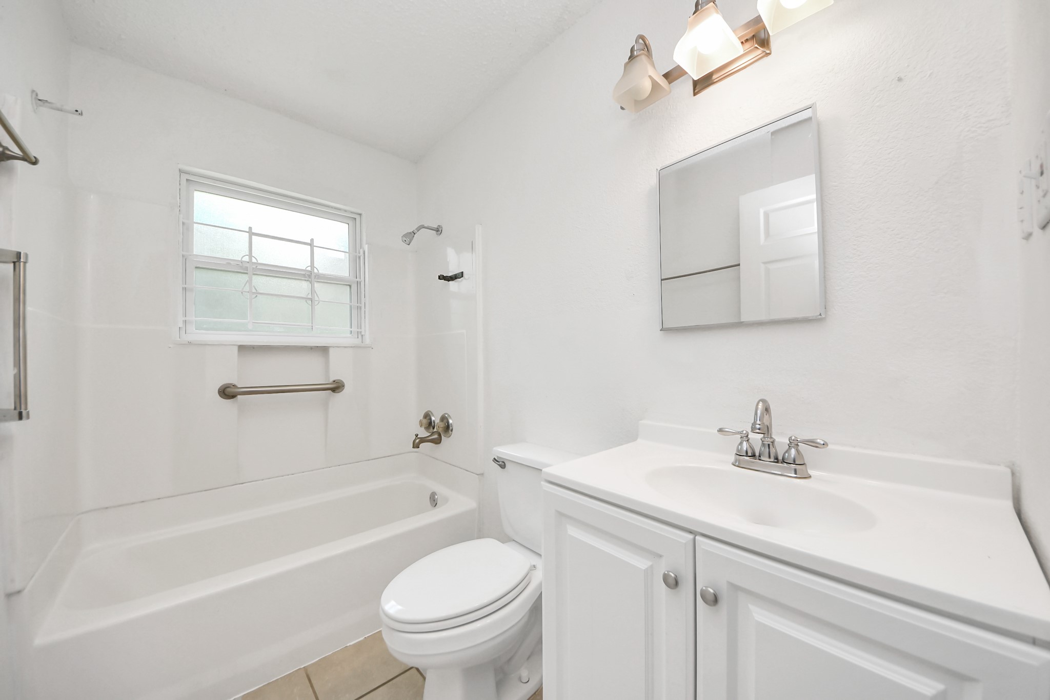 5202 Pensdale Street Houston, TX 77033 - Photo 14 of 32 a bathroom with a sink a toilet and shower