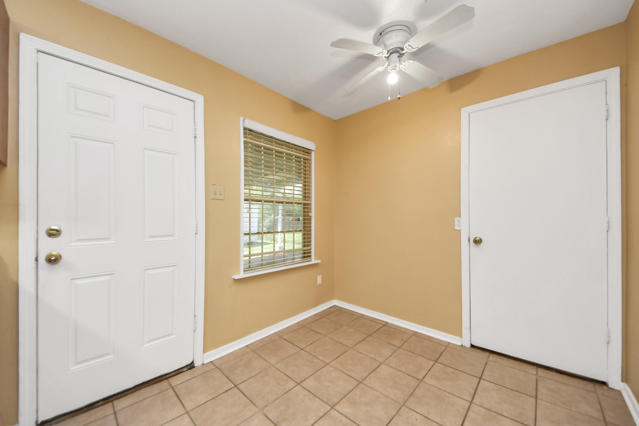 5202 Pensdale Street Houston, TX 77033 - Photo 26 of 32 an empty room with windows and fan