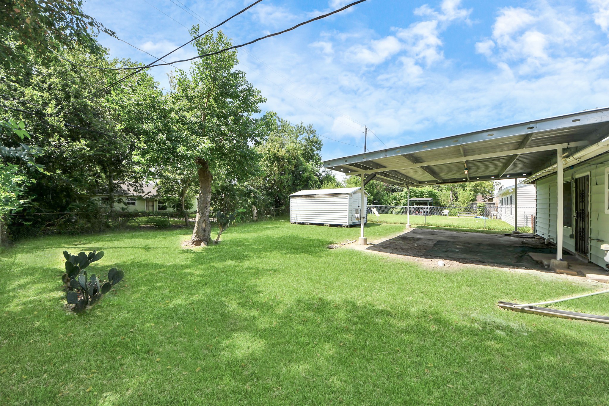 5202 Pensdale Street Houston, TX 77033 - Photo 28 of 32 a view of a park with a bench and a slide