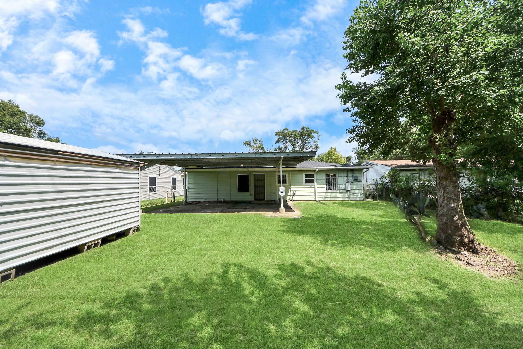 5202 Pensdale Street Houston, TX 77033 - Photo 29 of 32 a front view of house with yard and green space