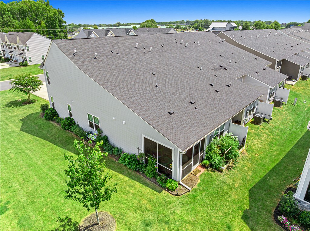 261 Scenic Road Anderson, SC 29621 - Photo 28 of 35 Manicured green lawn surrounds a modern townhome with a dark shingle roof and screened porch.