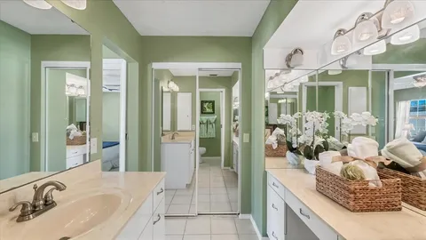 a spacious bathroom with a granite countertop sink a mirror and a shower
